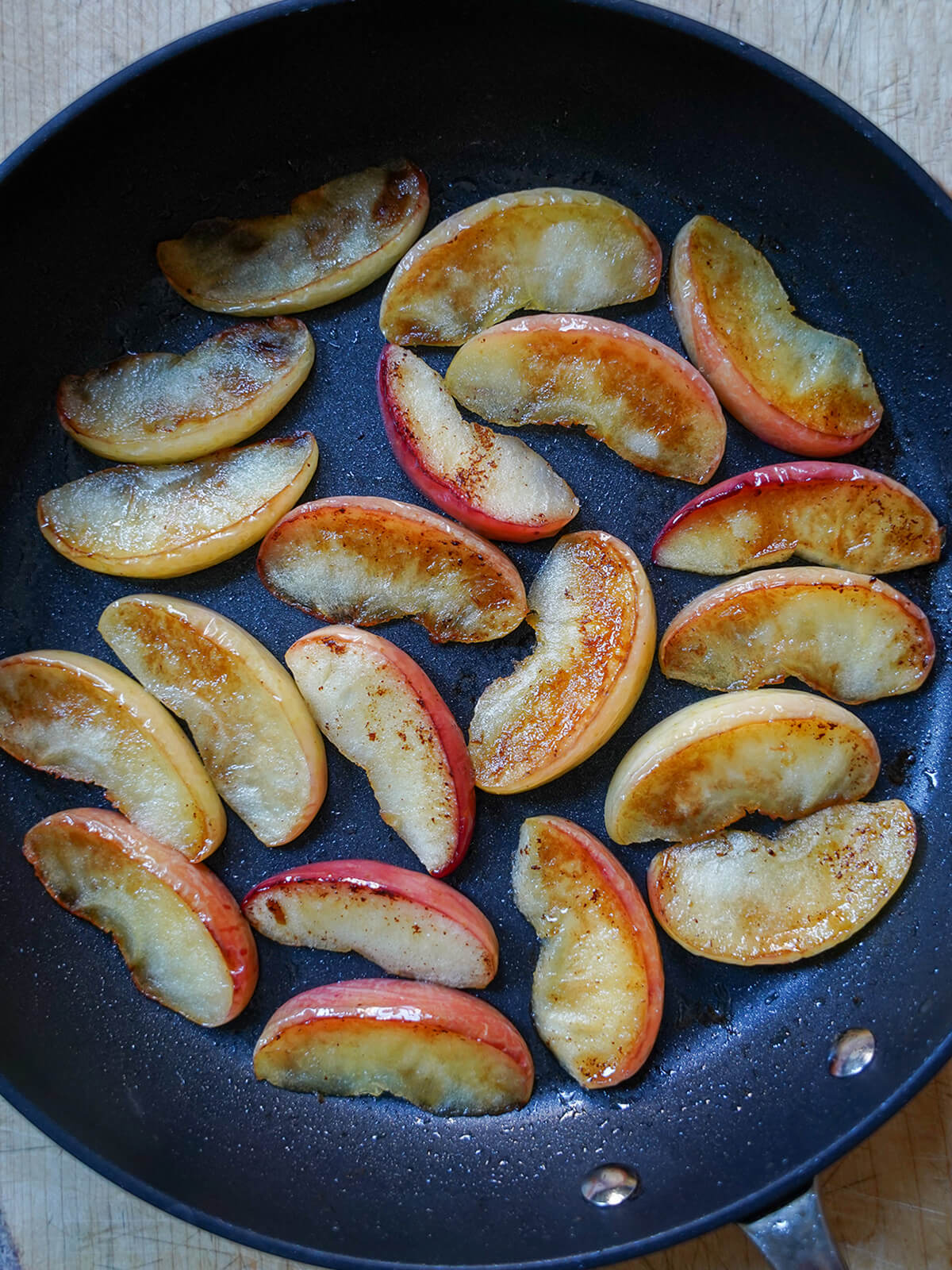 fried apple slices in skillet.