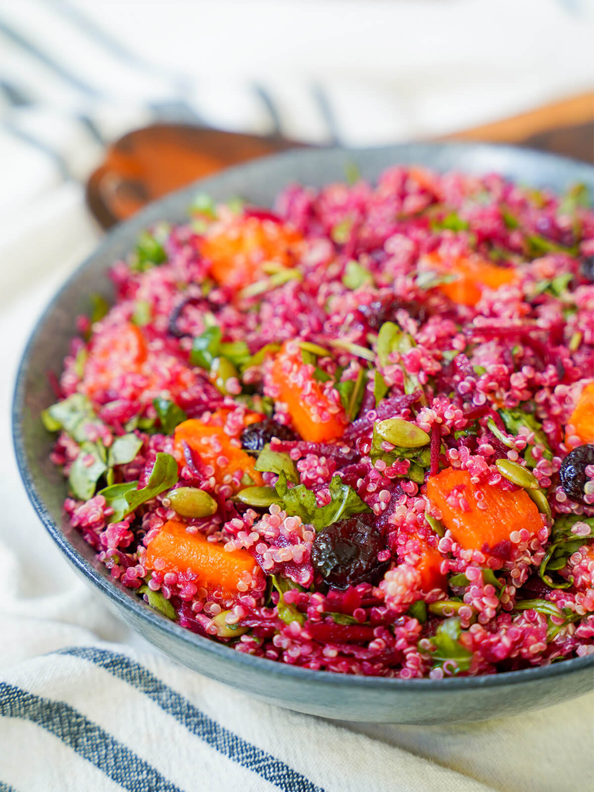 part side view of butternut squash quinoa salad in bowl.