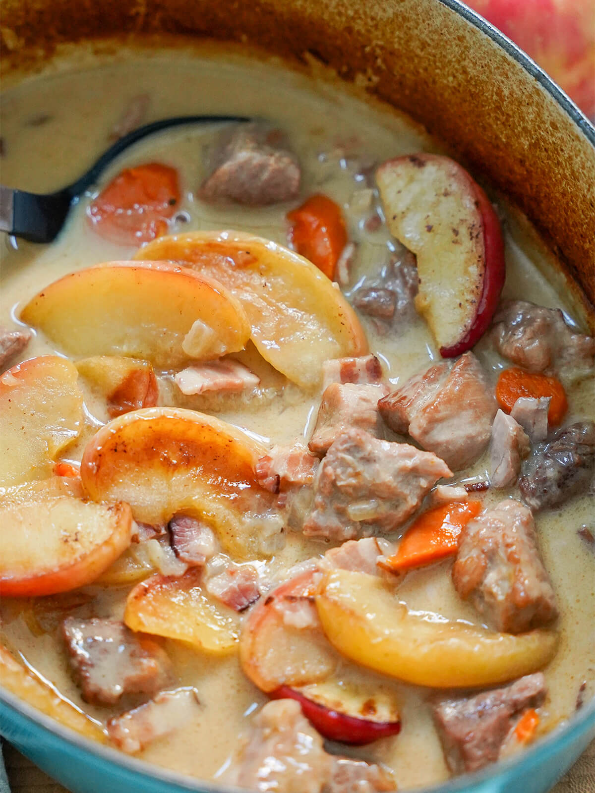 close up view of pot of pork and cider casserole.