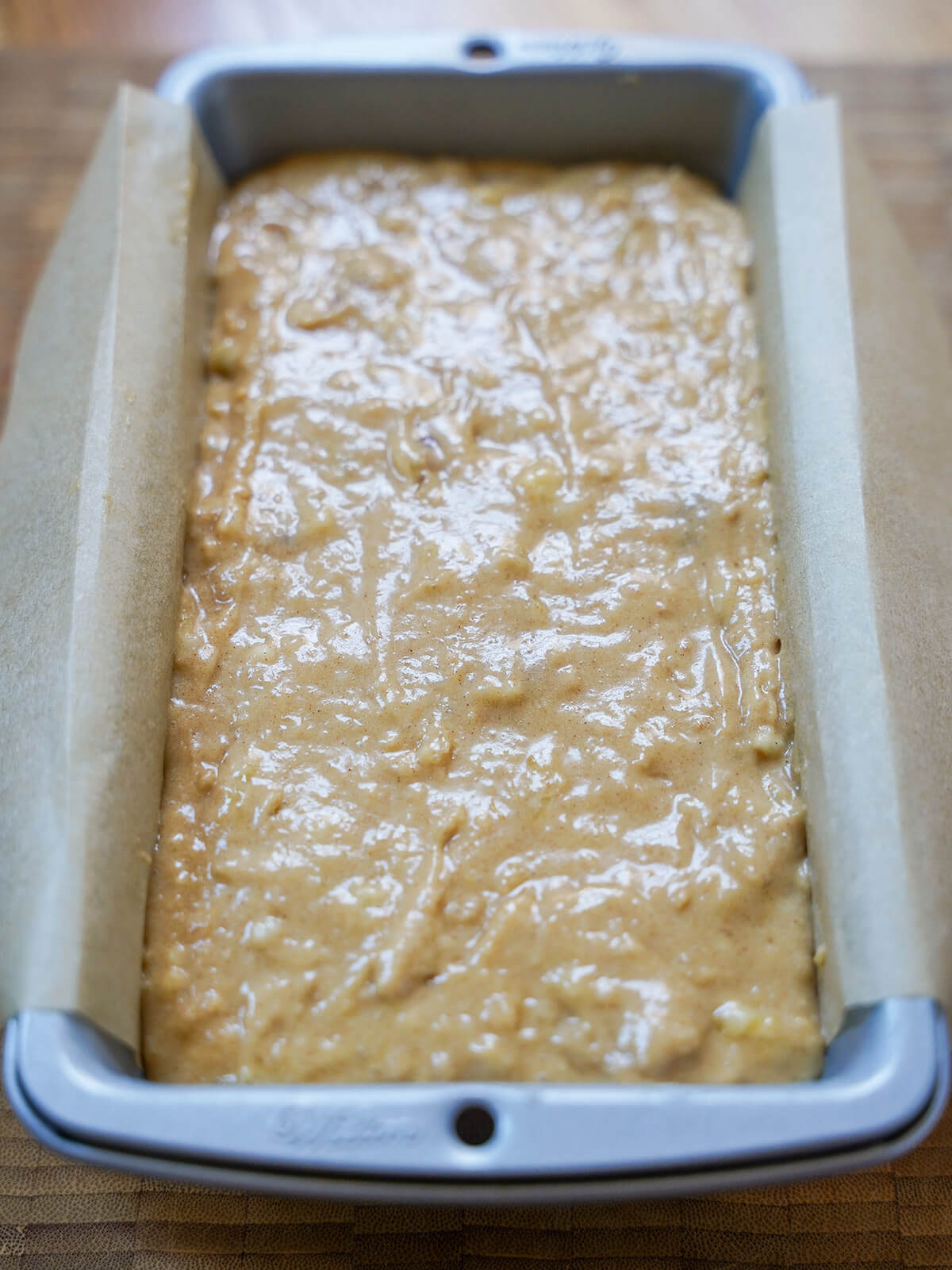 batter in loaf pan lined with parchment.