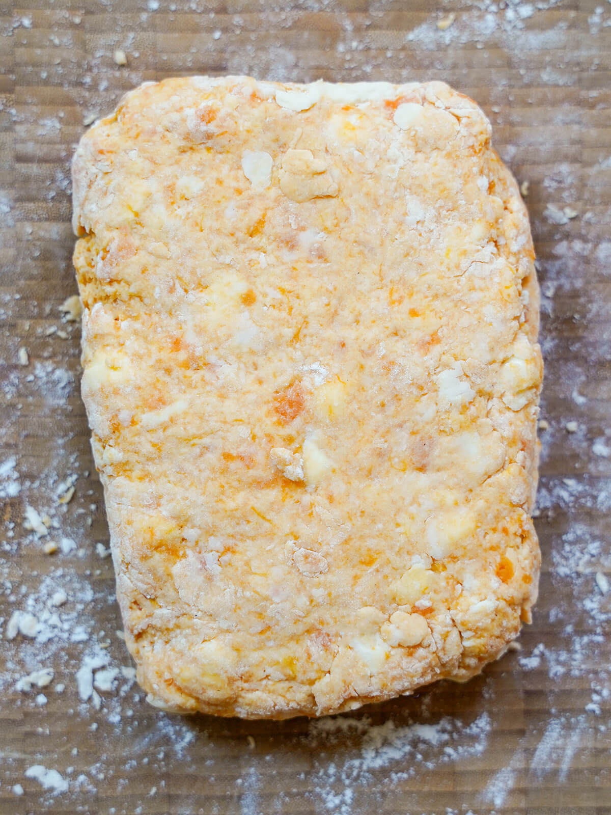 rectangle of sweet potato biscuit dough on floured board.