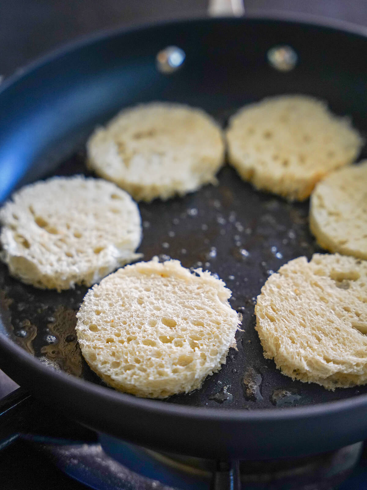 frying circles of bread in butter in a large skillet.