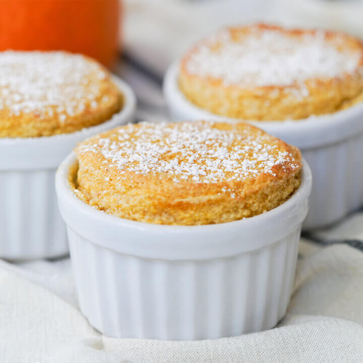 close side view of a pumpkin souffle with part view of others behind.
