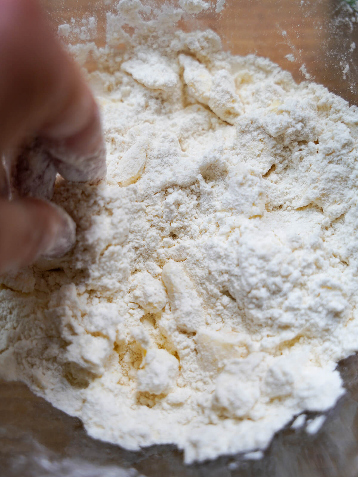 rubbing butter into flour in a bowl.