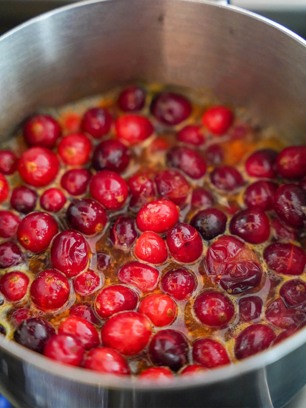 cranberries in a small saucepan with orange juice.