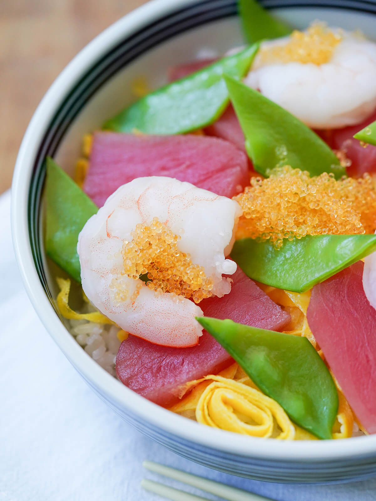 close up view of part of bowl of chirashi sushi.
