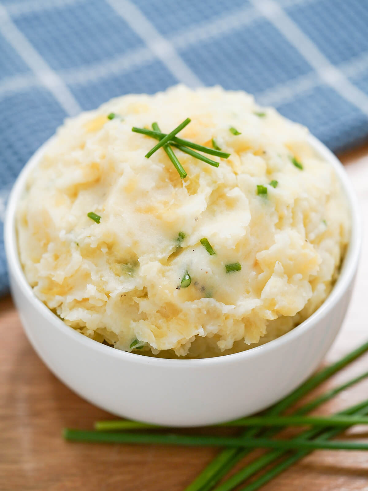 bowl of clapshot, potato and rutabaga mash, with chives under bowl.