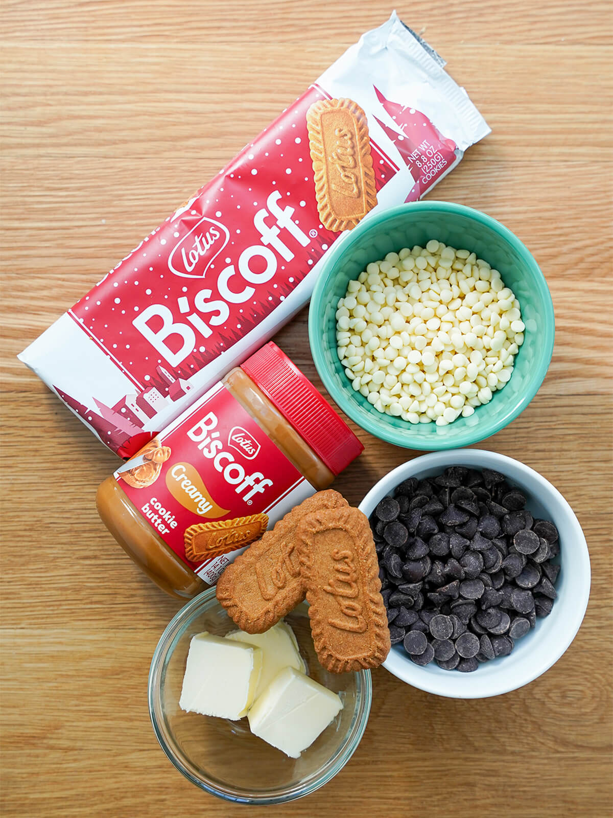 packed of biscoff cookies, jar of biscoff cookie butter, white and dark chocolate and dish with butter.