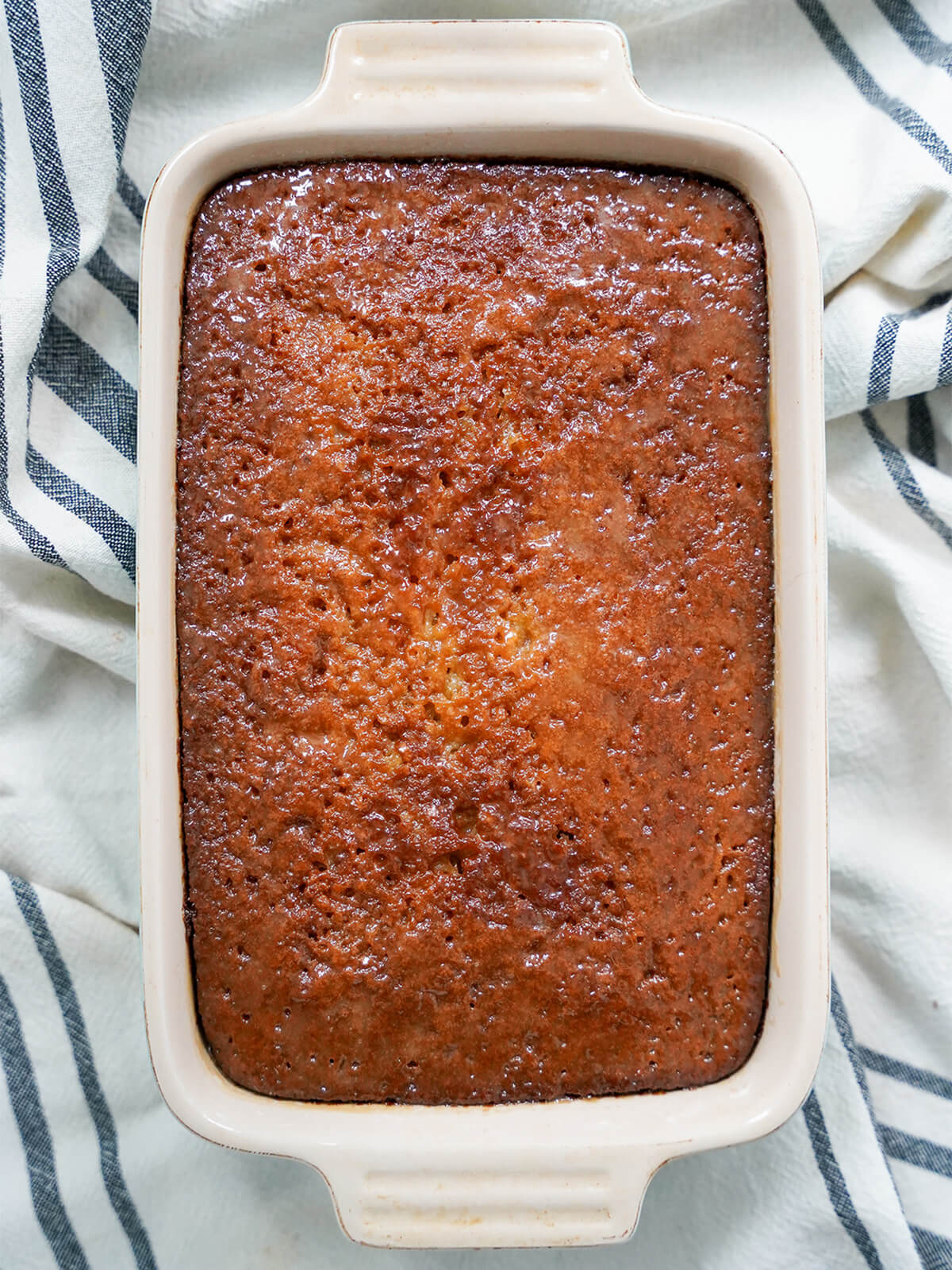 whole malva pudding with sheen on top since sauce has soaked in.