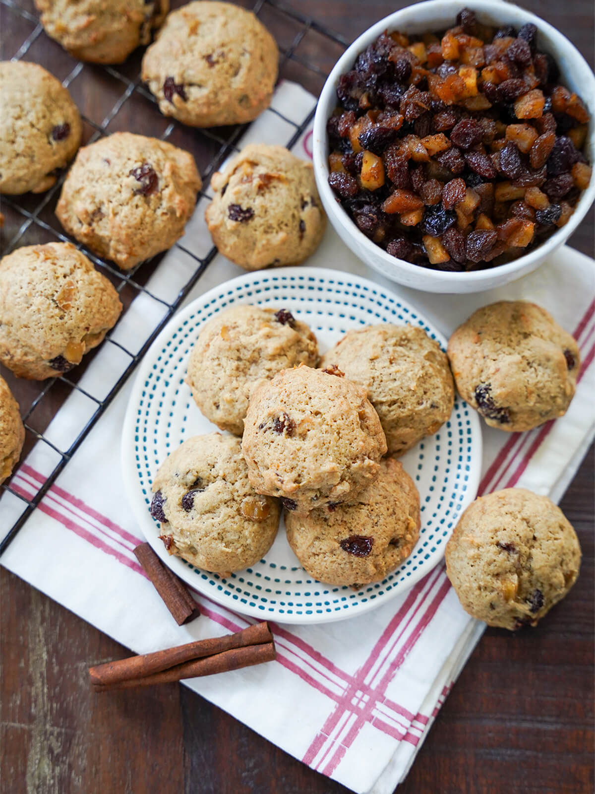 overhead view of plate with mincemeat cookies, bowl of mincemeat and some cookies to side on cloth