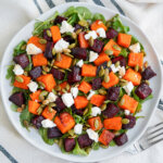 overhead view of a plate of roasted beet and butternut squash salad.