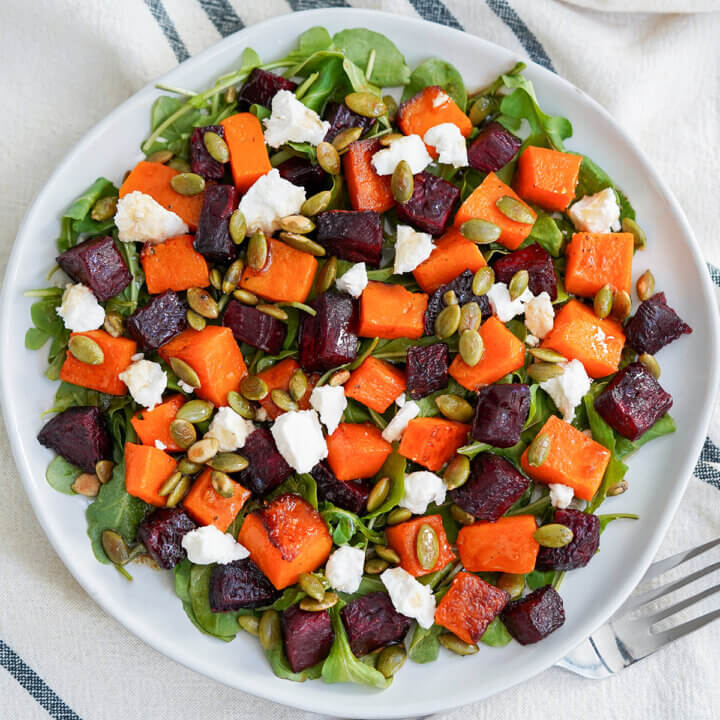 overhead view of a plate of roasted beet and butternut squash salad.