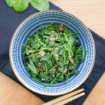 Japanese spinach salad, horenso gomaae, in a bowl viewed from overhead.