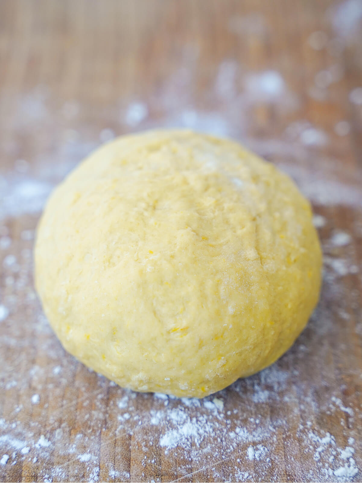 ball of fresh pumpkin pasta dough on board ball of fresh pumpkin pasta dough on board sprinkled with flour.