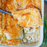 corner pastry of chicken and leek pie with tarragon on top pie showing filling below.