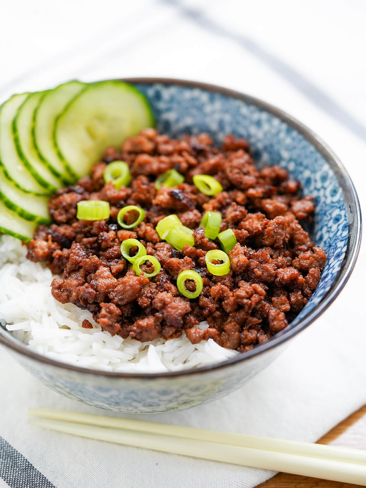 side view of Taiwanese minced pork rice with chopsticks below bowl.
