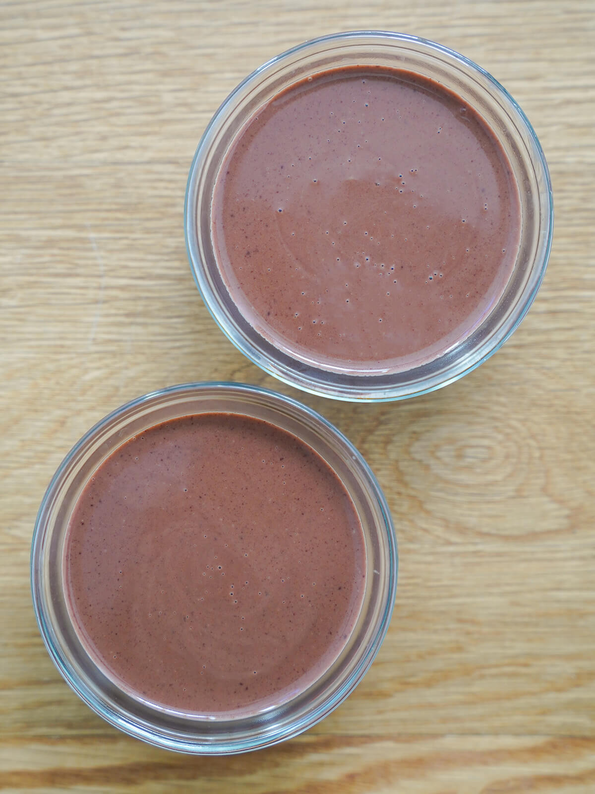 dishes with chocolate panna cotta mixture in them before set.