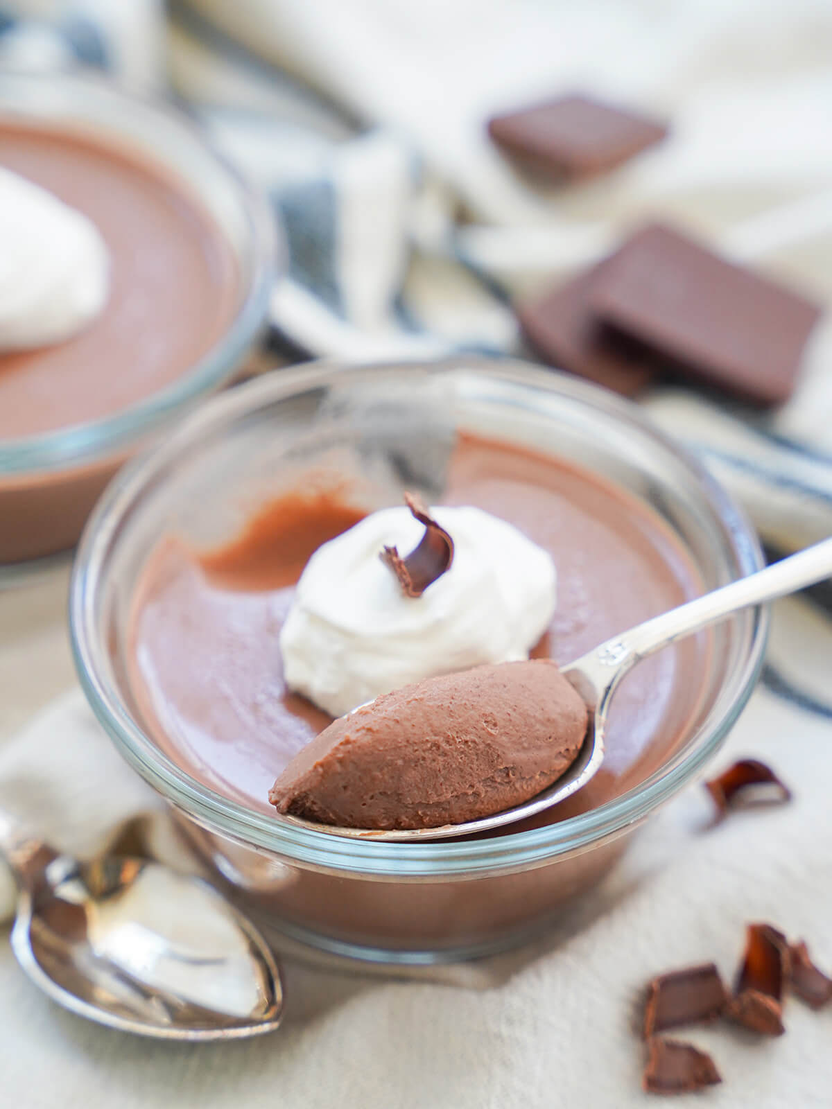 spoon with scoop of chocolate panna cotta resting on rest of dessert.