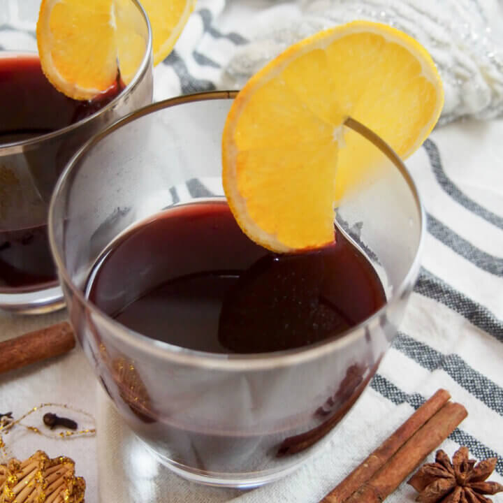 glass of gluhwein garnished with a slice of lemon.