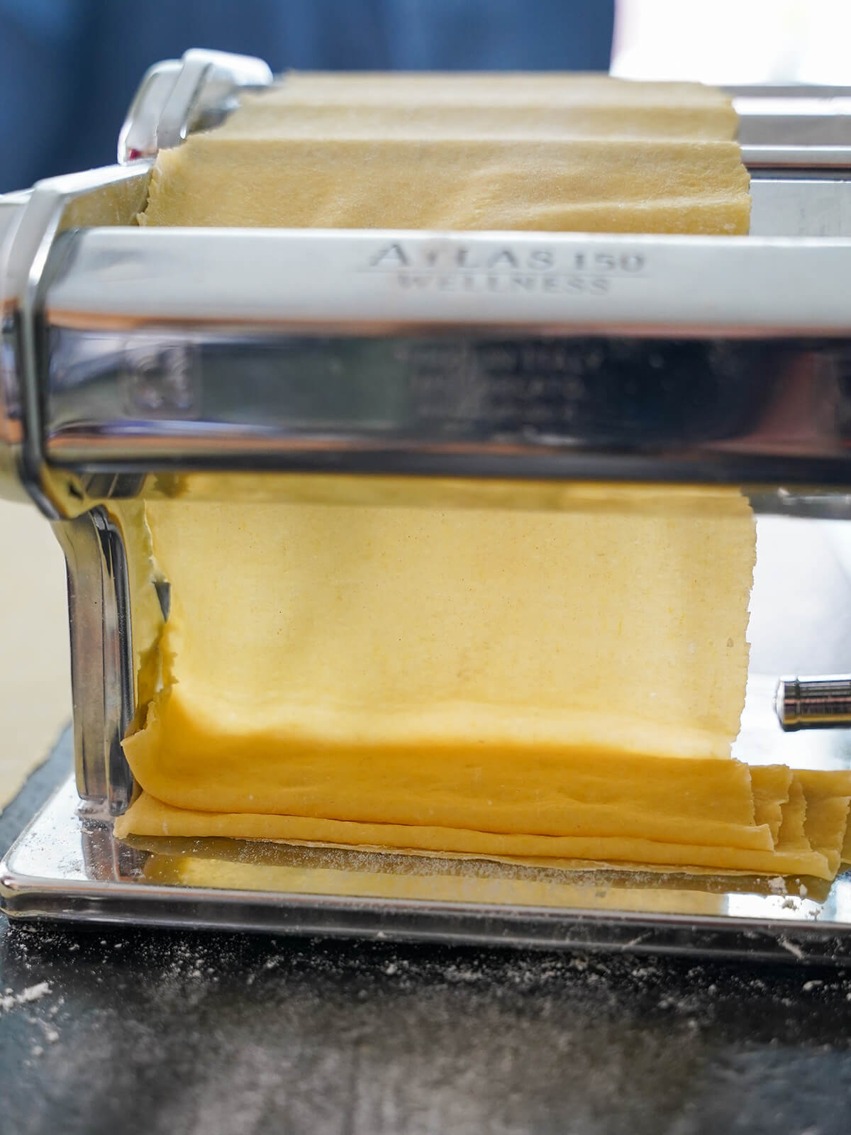 rolling dough very thin through pasta machine.