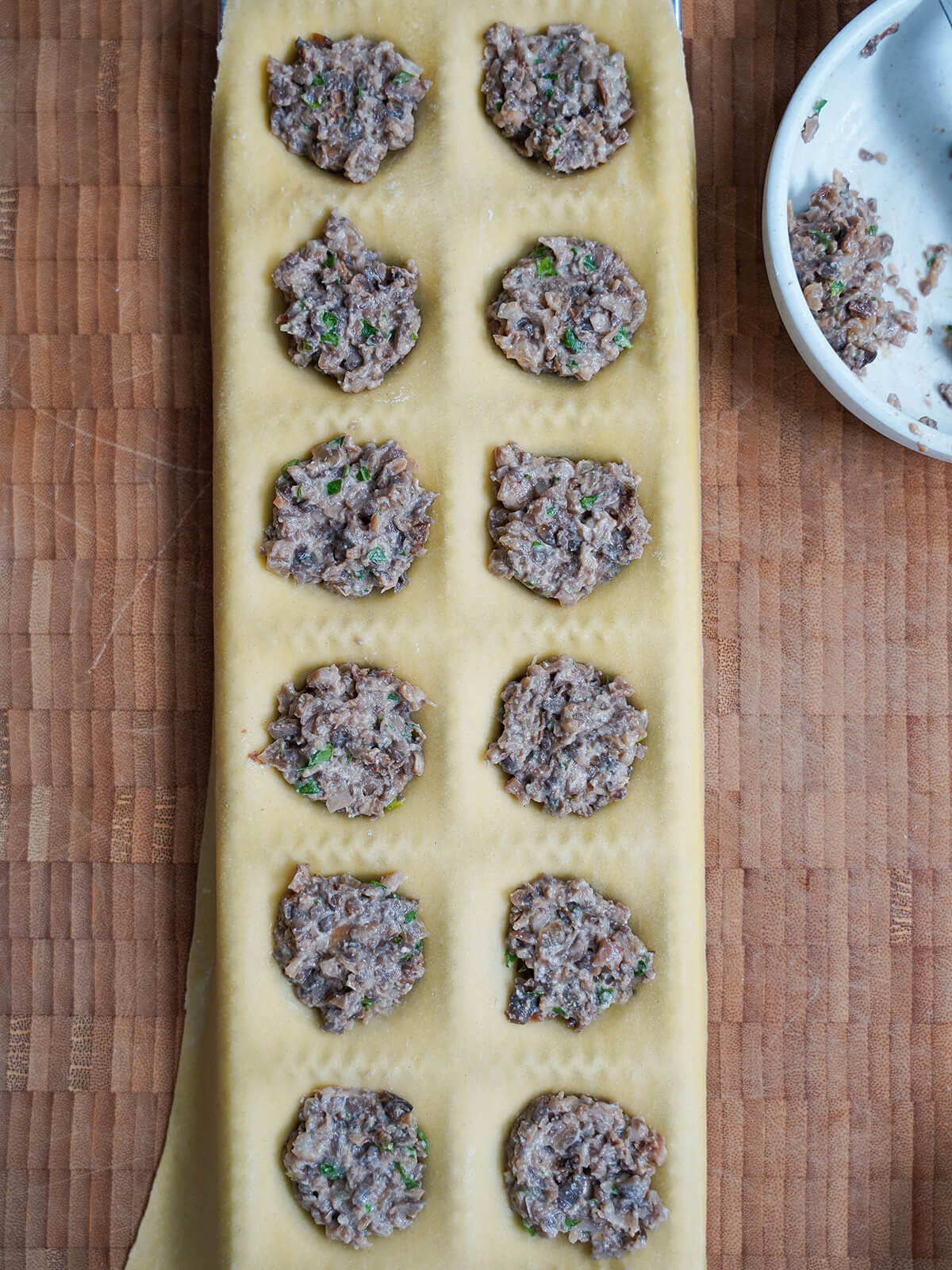 mushroom filling on top of pasta dough in mould.