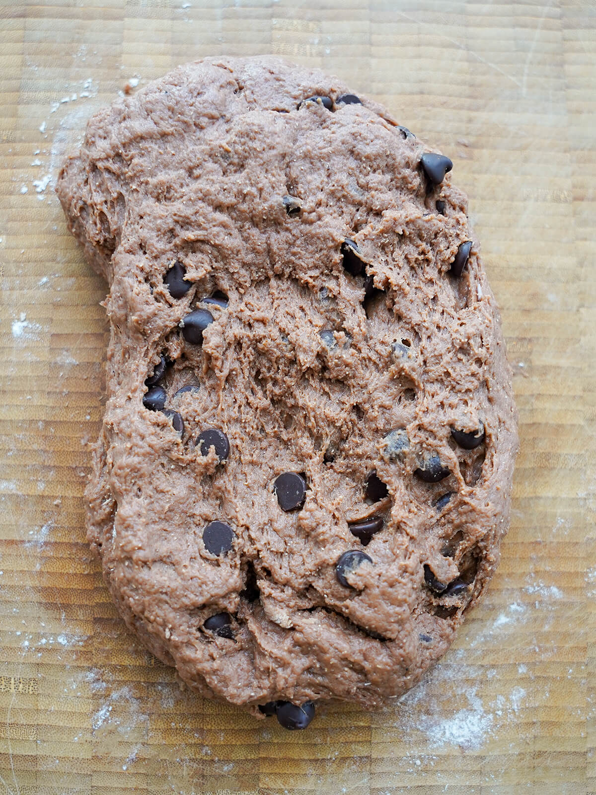 chocolatey dough with chocolate chips mixed in on board.