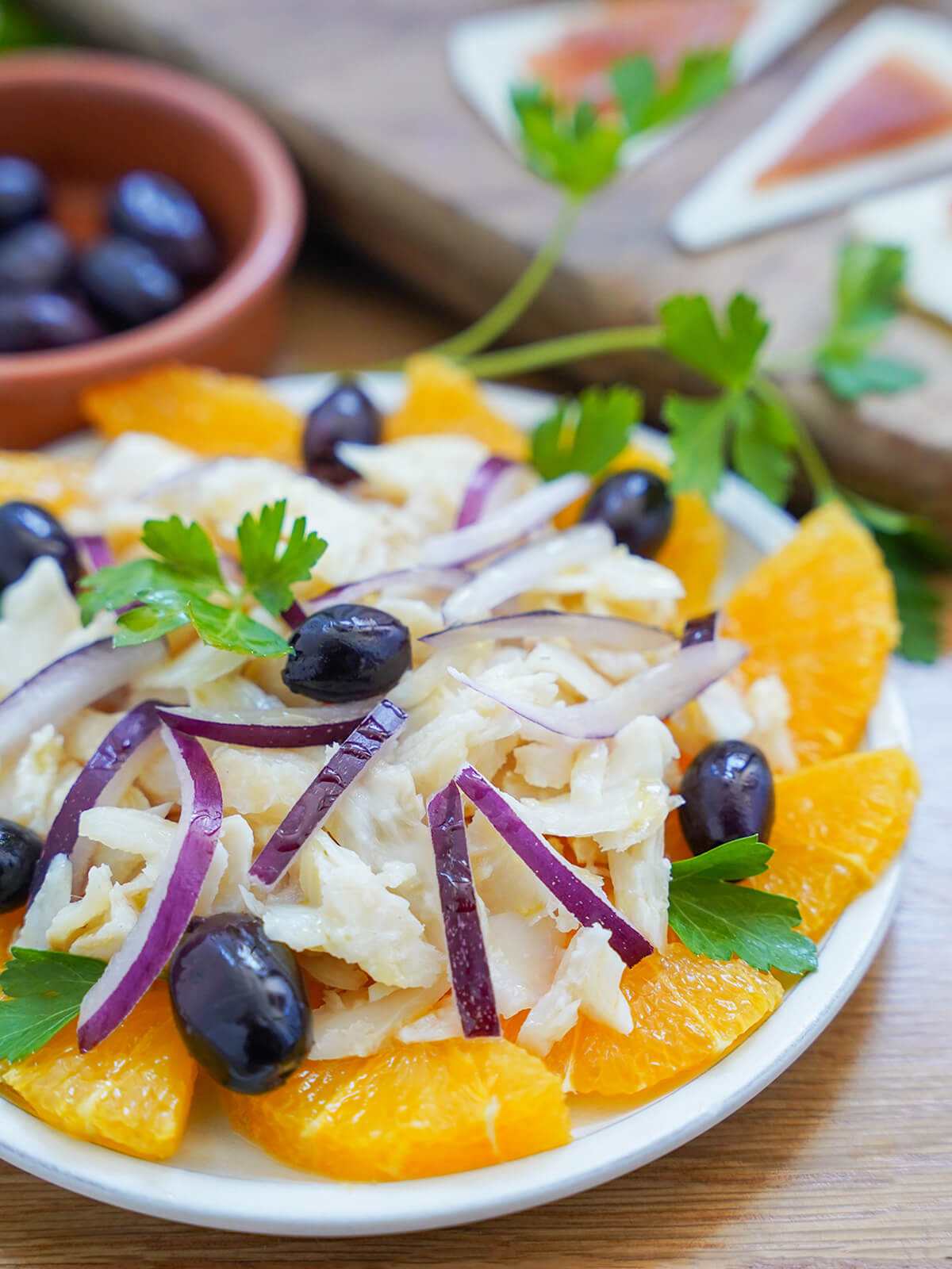 side partial view of plate of remojon, salt cod orange salad.