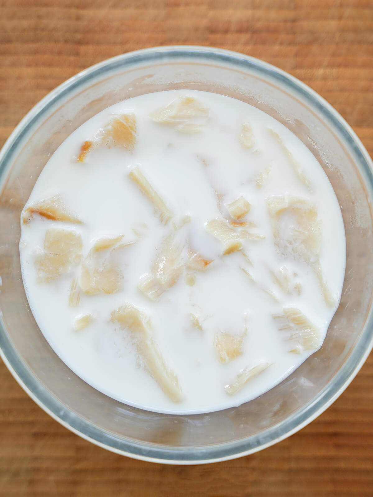 salt cod pieces soaking in warm milk