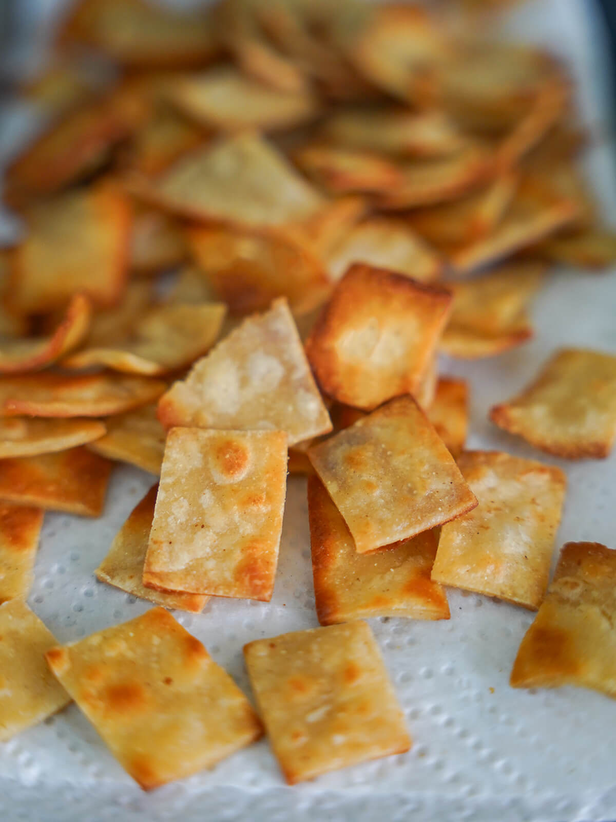 fried tortilla pieces draining on kitchen paper.