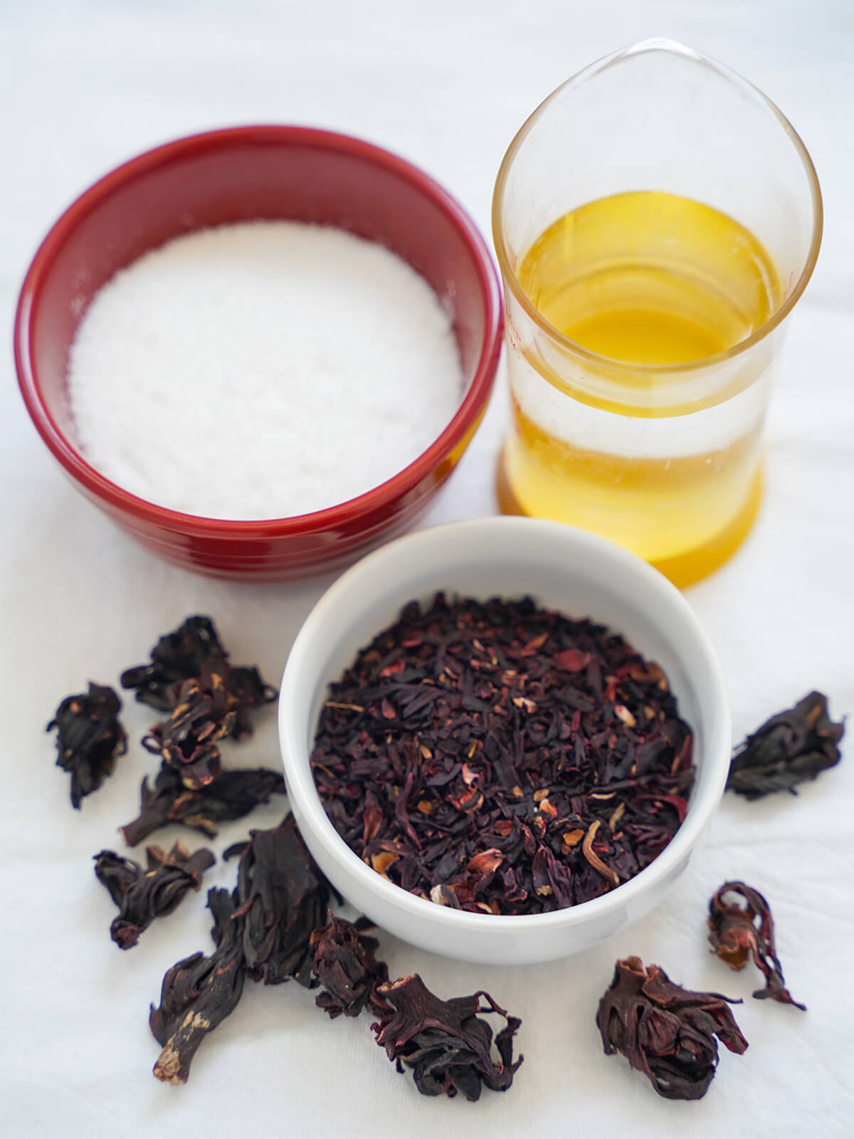 bowls of sugar, cut hibiscus flowers and measure with water.