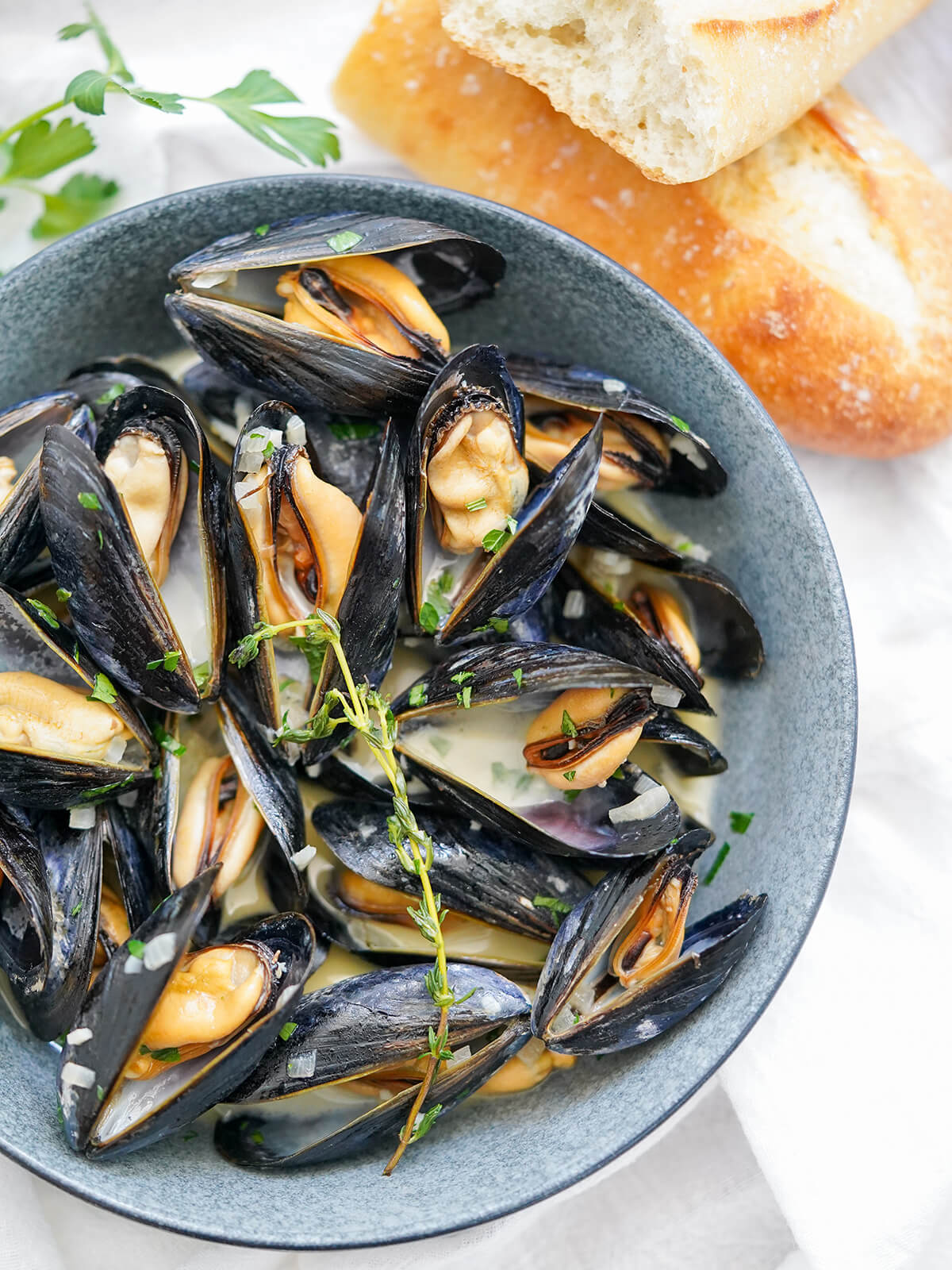 Mussels in cream is a wonderfully easy seafood dish of mussels in a light, creamy and flavorful broth. It's quick, relatively inexpensive and delicious. close overhead view of bowl of mussels in cream
