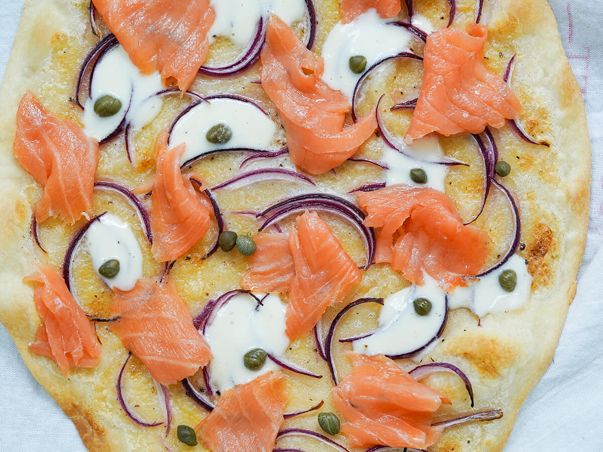 smoked salmon pizza close up of smoked salmon pizza.