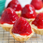 close view of strawberry tartlets on rack.