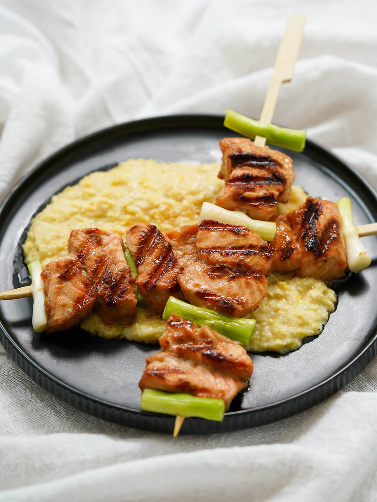 salmon teriyaki skewers served over corn puree.