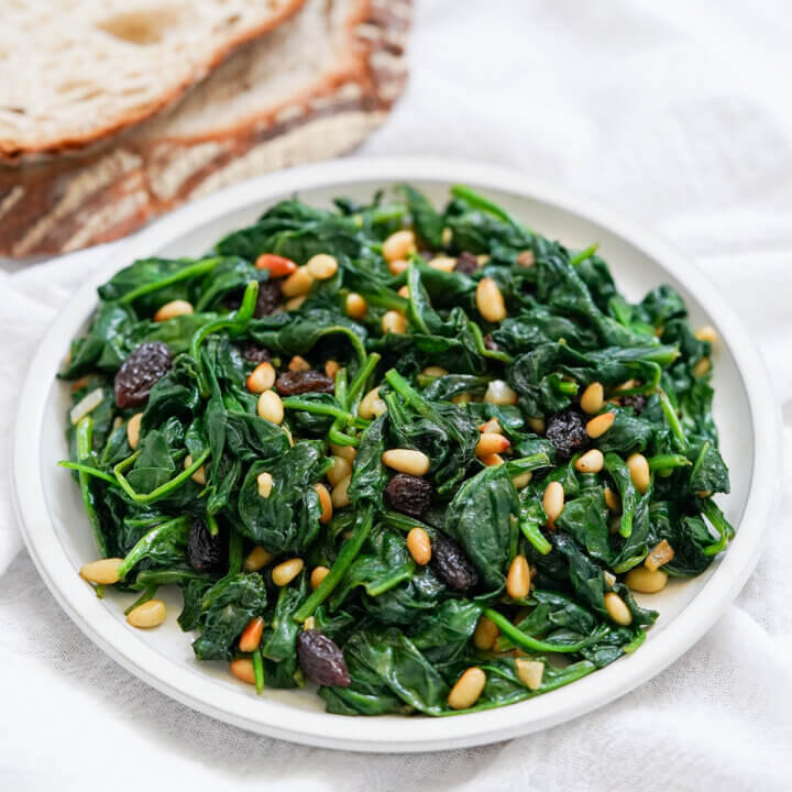 small plate of Catalan spinach with pine nuts and raisins.