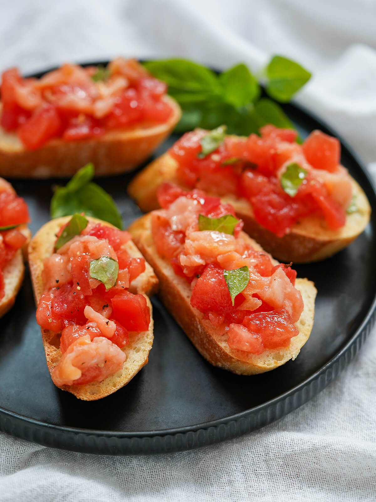 pieces of smoked salmon bruschetta on plate.