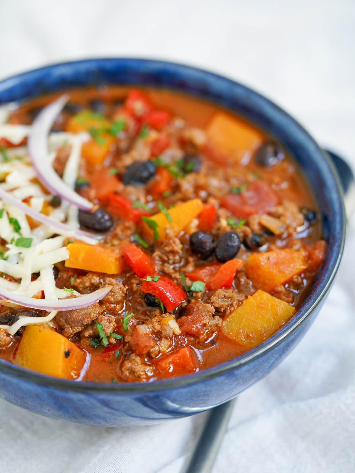 side view of bowl of chili with butternut squash.