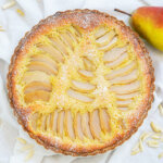 overhead view of pear frangipane tart dusted with powdered sugar.
