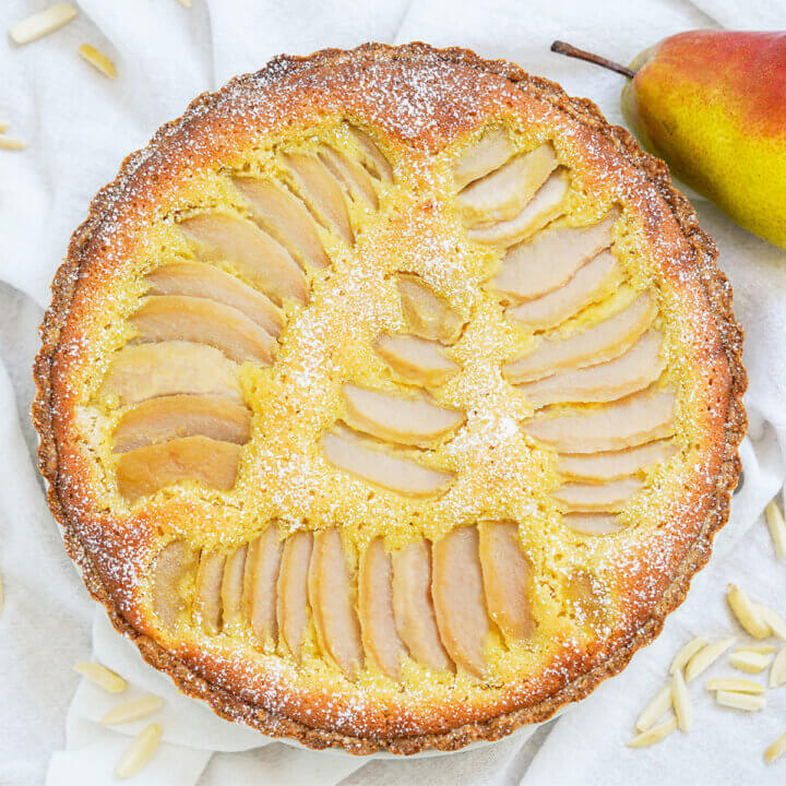 overhead view of pear frangipane tart dusted with powdered sugar.