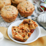 close up of Christmas pudding muffins with one split open in front of others.