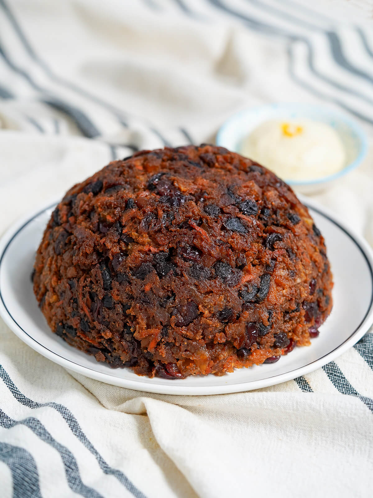 whole Christmas pudding on plate.