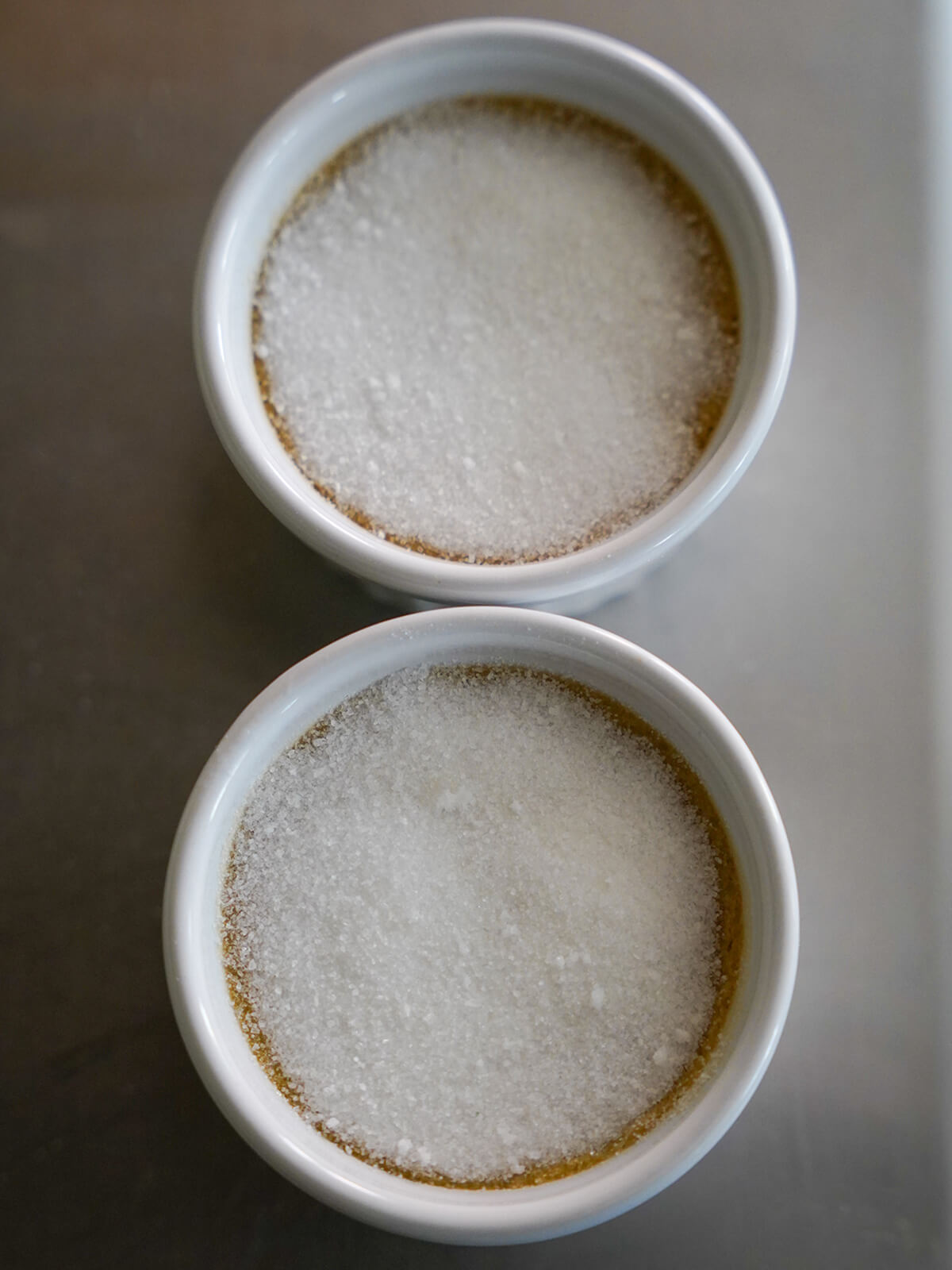 two dishes topped with sugar.