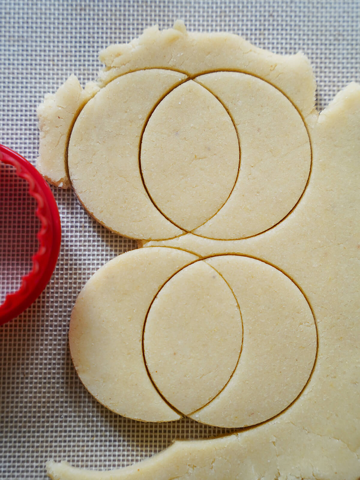 cutting moon shaped cookies from dough by using two circles overlapping.
