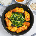 overhead view of skillet of Vietnamese turmeric fish, cha ca la vong.