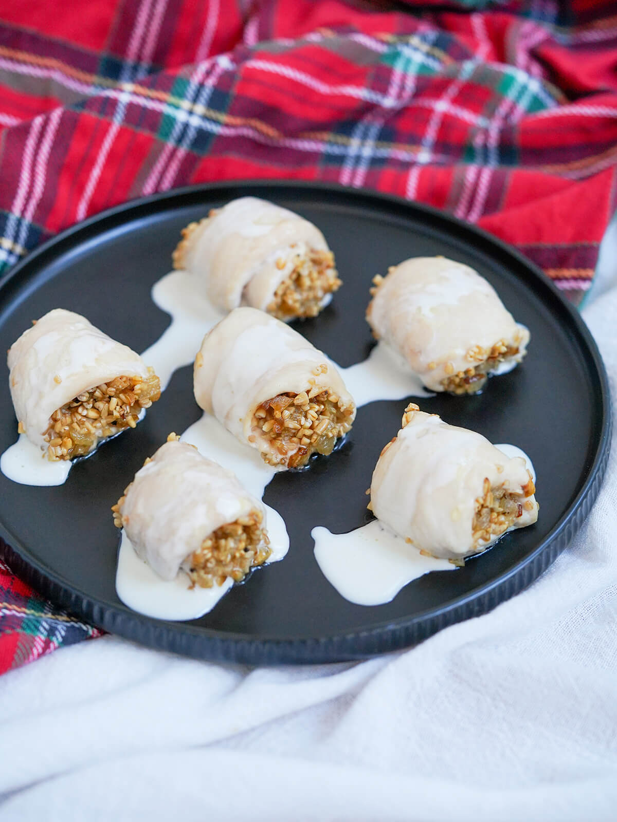 plate of chicken with oatmeal stuffing with tartan behind plate.