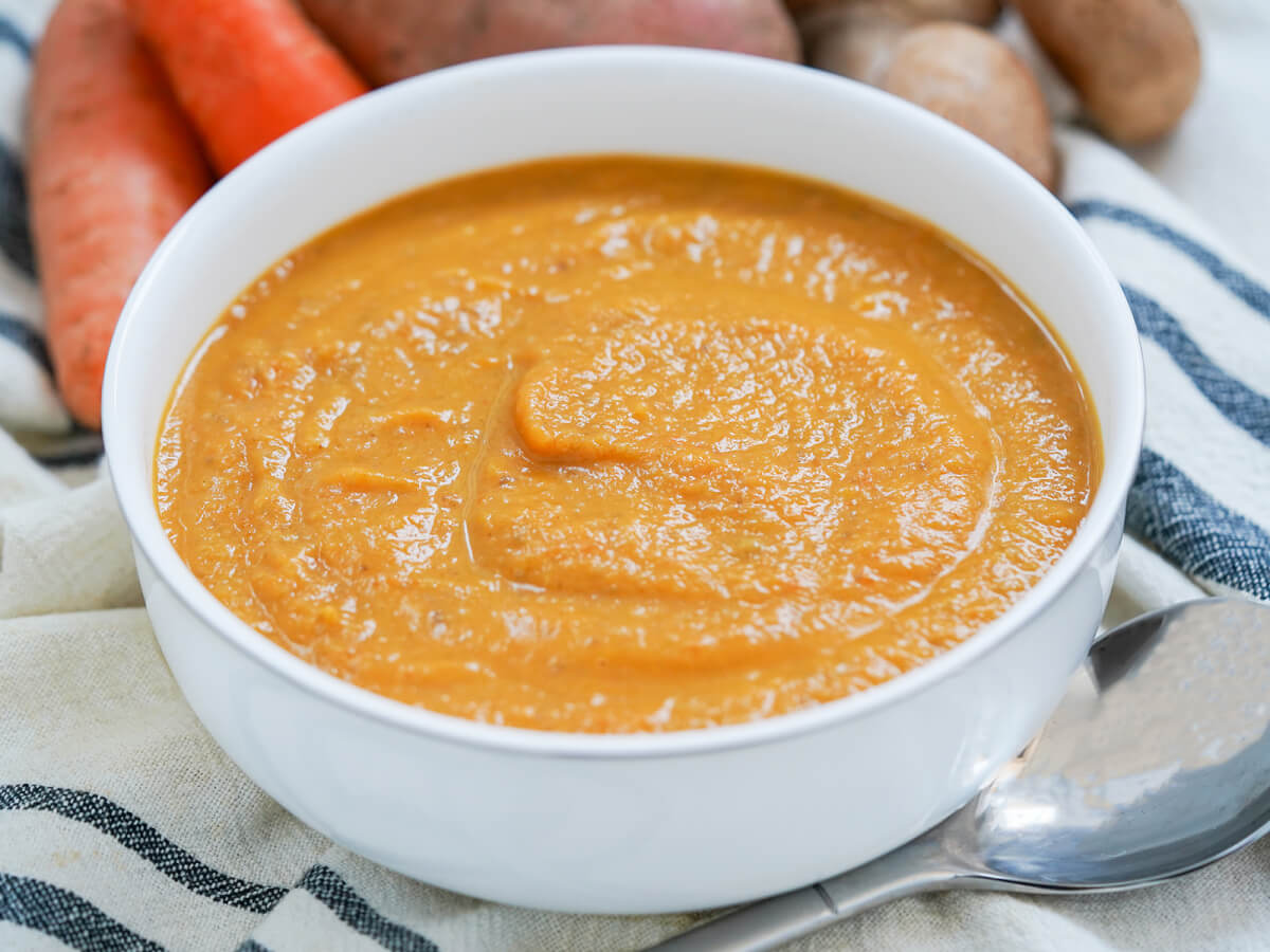 side view of bowl of mushroom carrot and sweet potato soup
