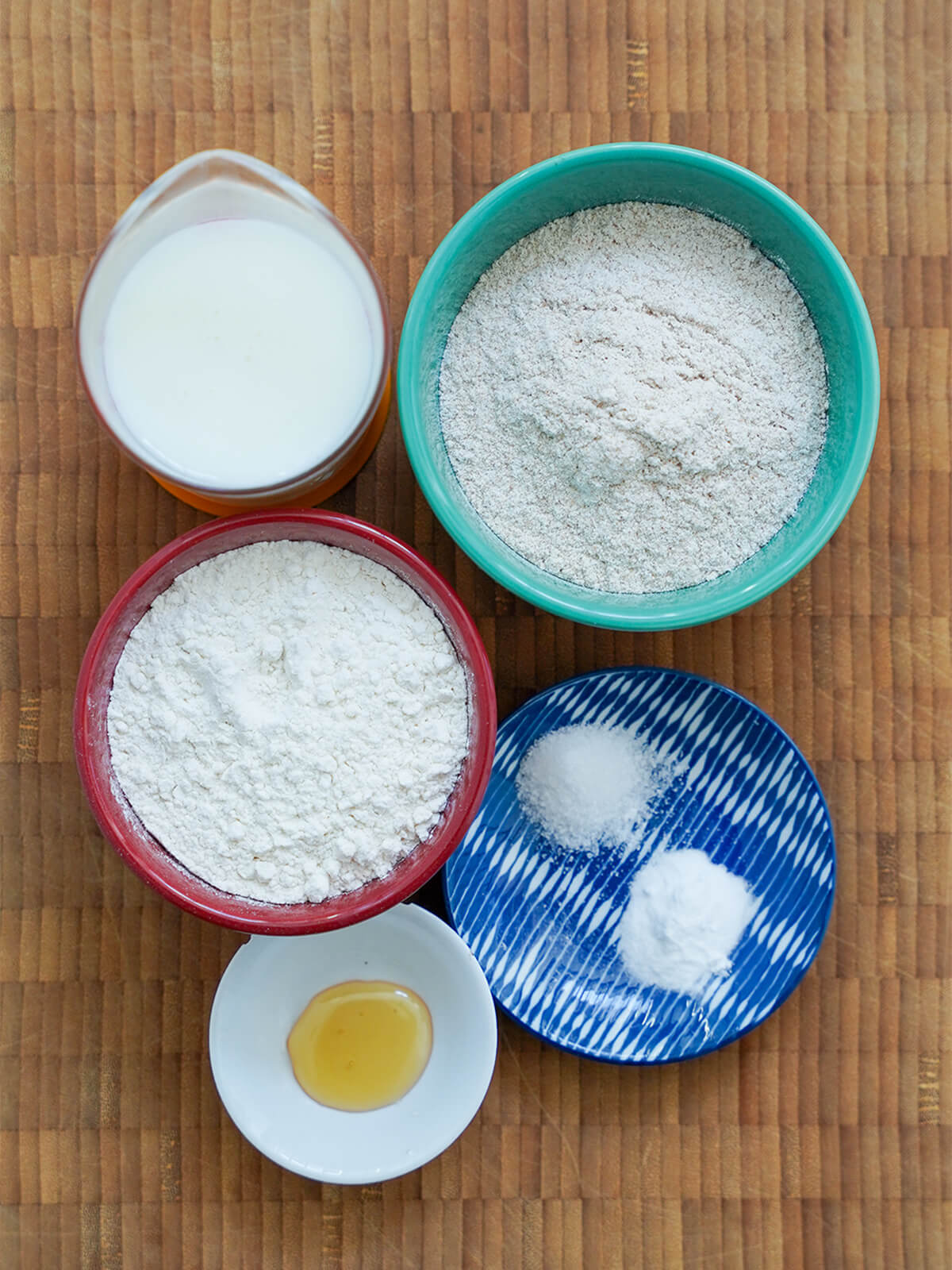 bowls of flour, measure with milk, small dish with salt and baking soda.