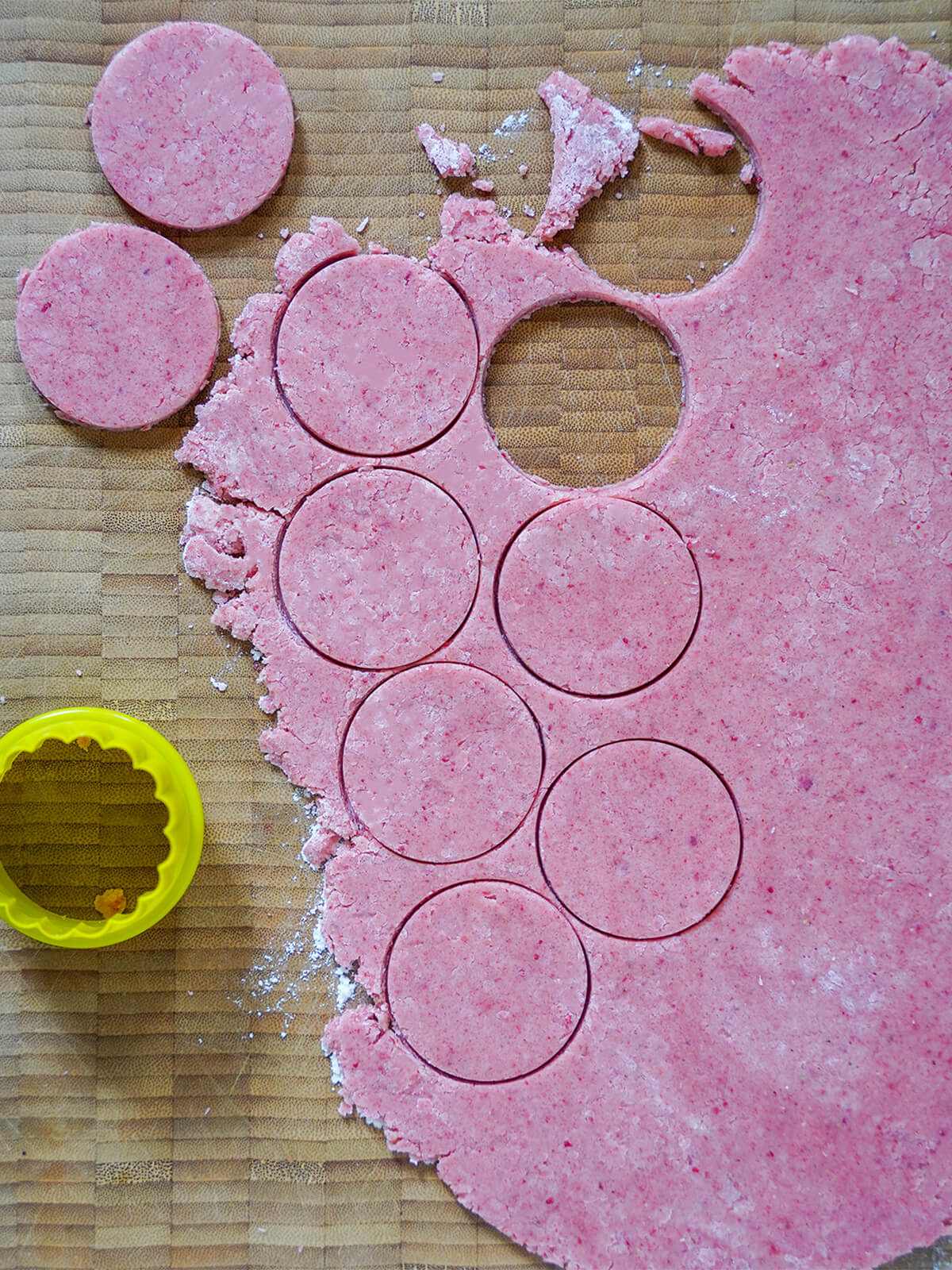 cutting cookie circles from rolled out dough.