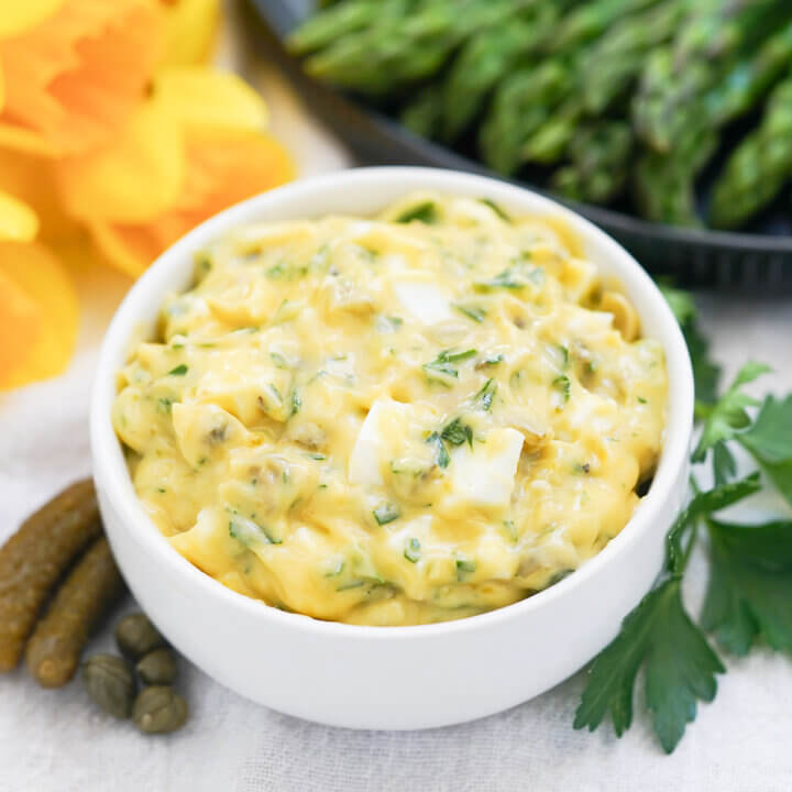 bowl of sauce gribiche wirh ingredients in it to sides.